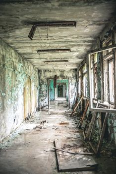 ruined abandoned class room with desks and blackboards in Pripyat school