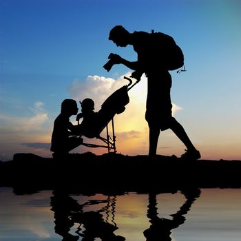 Dad photographing of their children at sunset