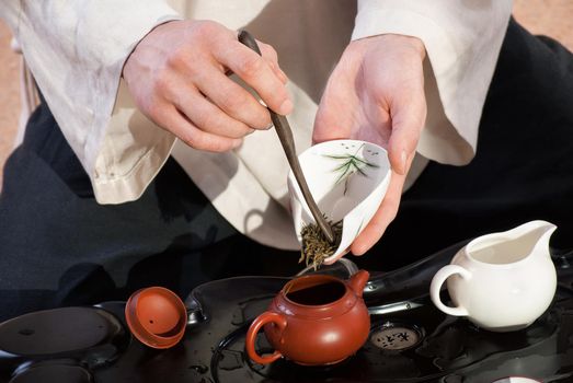 Chinese tea ceremony is perfomed by tea master in kimono