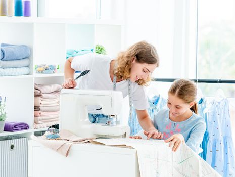 Tailor is teaching student at workshop