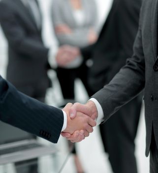 close-up of handshake business partners on blurred background