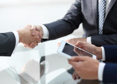 handshake business colleagues in office