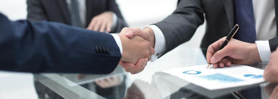 handshake business colleagues in office