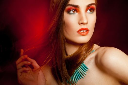 Beautyful woman with creative make-up over dark background