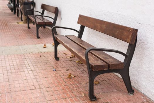 Wooden bench in the city park outdoors.