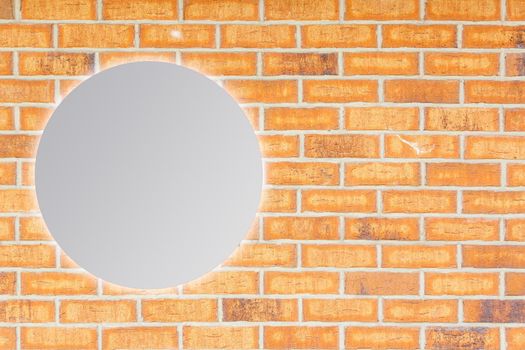 Round mirror near brick wall