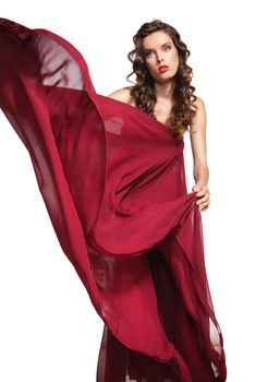 woman in red dress waving flying on wind flow with long curly hair