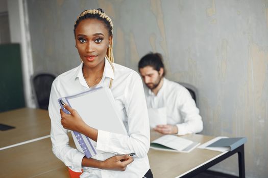 Handsome man in a white shirt. African woman with partner. Guy with a laptop.