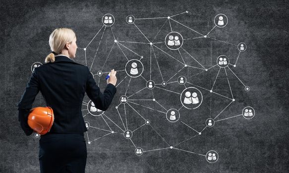 Businesswoman designing social network interaction structure. HR specialist in business suit with safety helmet. Recruitment agency presentation. Human resource management and career development.