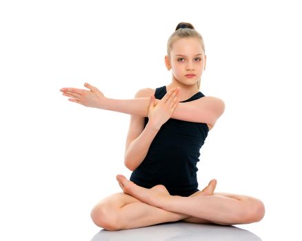 A nice little girl sits in a lotus position and meditates. Concept of yoga, happy people. Isolated on white background.