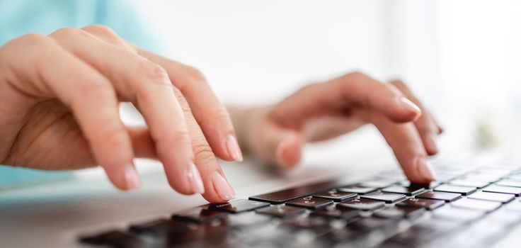 Girl hands typing on laptop keyboard closeup view. Female woman person working with computer