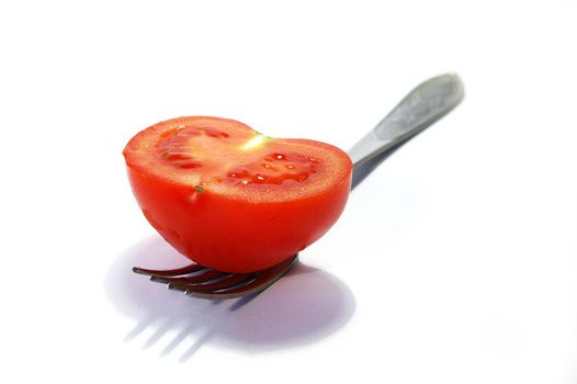 Fork and tomato isolated on a white background