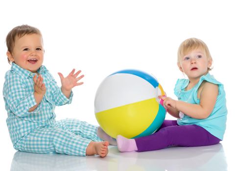 Toddler boy and girl playing with ball. The concept of a harmonious development of a child in the family, a happy childhood. Isolated on white background.