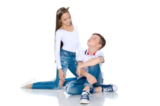 Teens brother and sister. The concept of a happy childhood, beauty, people, fashion, healthy lifestyle. Isolated on white background.