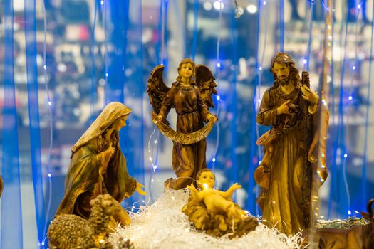Christmas nativity scene photograph of Mary, a king, a shepherd and lamb worshipping baby Jesus.