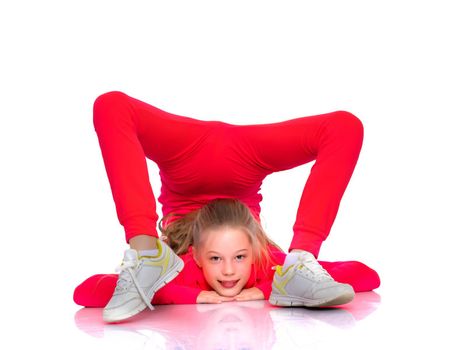 A girl gymnast performs an acrobatic element on the floor. The concept of childhood, sport, healthy lifestyle. Isolated on white background.