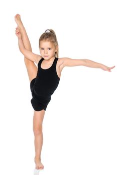 A girl gymnast balances on one leg.The concept of childhood, sport, a healthy lifestyle. Isolated on white background.