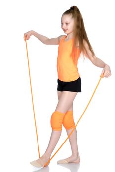 A girl gymnast performs exercises with a skipping rope. The concept of a healthy lifestyle, sports education of a child, Happy childhood. Isolated on white background.