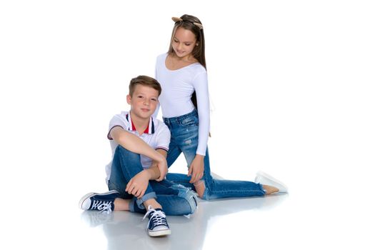 Teens brother and sister. The concept of a happy childhood, beauty, people, fashion, healthy lifestyle. Isolated on white background.