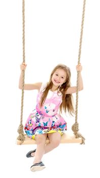 Beautiful little girl swinging on a swing. The concept of family happiness, summer holidays. Isolated on white background.