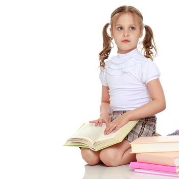 Little girl with book. The concept of education in school or kindergarten. Isolated over white background