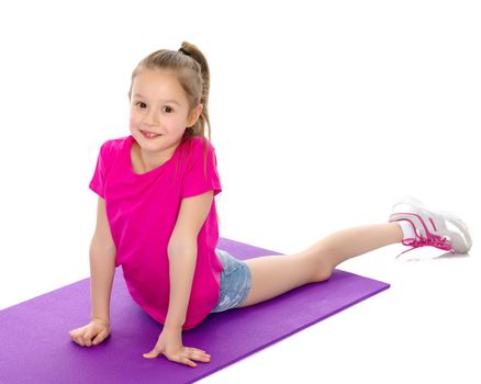 A gymnast girl prepares for the exercise. The concept of childhood and sport, a healthy lifestyle. Isolated on white background.