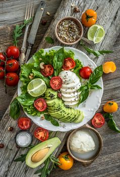 Vegetarian salad with mozzarella, avocado and tomatoes