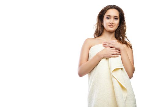portrait of young beautiful woman wrapped in towel after bath. Spa. Isolated over white background