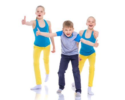 A group of cheerful, emotional children keep their thumbs up. The concept of advertising, sports and fitness. Isolated on white background.