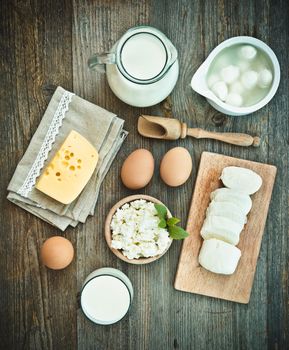 milk products on old wooden table. top view