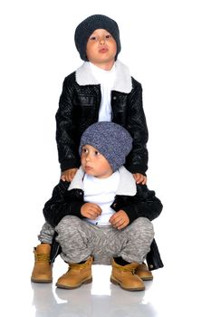 Studio portrait of boys in black leather jackets.Isolated on white background.