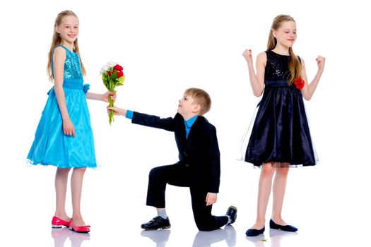 A little boy gives a little girl flowers. The concept of a happy childhood, love. Isolated on white background.