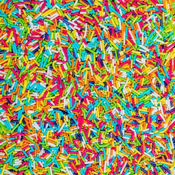 Background of colorful sprinkles, jimmies for cake decoration or ice cream topping