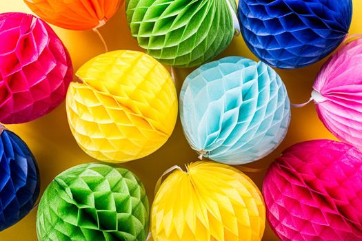 Festive background with colorful paper balls. Greeting card concept voor birthday, party, invitation, carnival. Top view, flat lay.