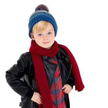 Cute little boy in a hat with a pompon and a scarf .Concept style, happy childhood.Isolated on a white background.