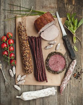 Assortment of cold meats over wooden background