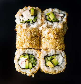 gorgeous sushi rolls over black