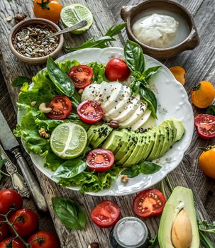Vegetarian salad with mozzarella, avocado and tomatoes