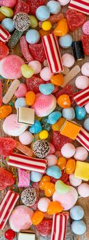 variety of candies on a wooden background with space for text