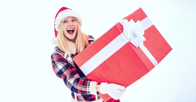 Santa woman with huge red gift looking at camera. Funny woman holding a big Christmas present