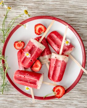 Delicious ice cream made at home, rustic and sweet, strawberries and banana flavor, topview