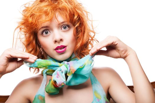 Girl with beautiful red hair and colorful dress and fabric over white background