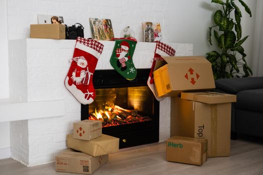 KYIV, UKRAINE - November 16, 2020: boxes Nova Poshta with delivery of Christmas gifts lie near the fireplace