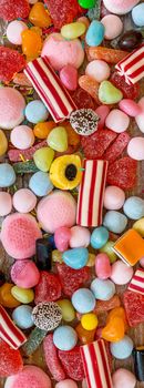 variety of candies on a wooden background with space for text