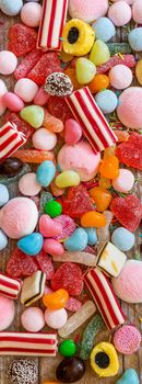 variety of candies on a wooden background with space for text