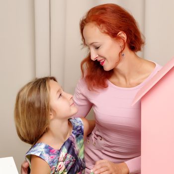 Young mother and little daughter gently embrace. The concept of Happy Childhood, Family Happiness, Raising a Child.