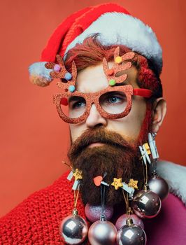 Bearded Santa Claus close up portrait. Funny christmas face of Santa claus, bearded hipster