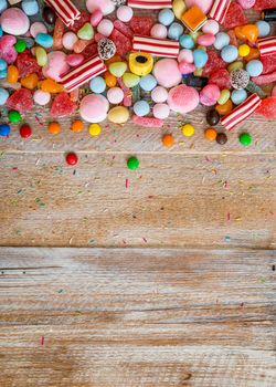 variety of candies on a wooden background with space for text