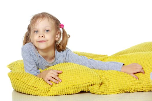 A little girl lies on a pillow. Concepts of family happiness, people, child, Healthy sleep, beauty and relaxation. Isolated on white background.