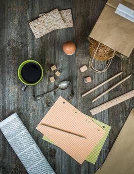 breakfast business person. coffee, sheets of notes and stationery on wooden table. top view